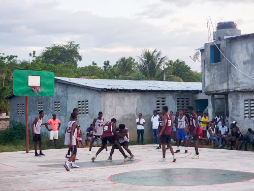 High school basketball players competing during an outdoor interschool tournament in Haiti.