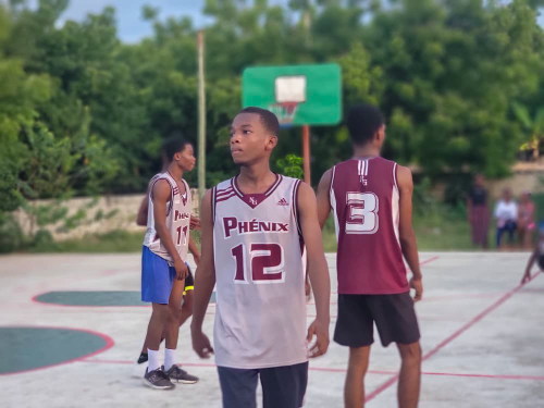 Student athlete wearing a basketball jersey during a youth sports competition in Haiti.