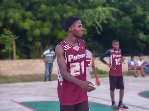 Young student basketball players standing on an outdoor court during an interschool competition in Anse-à-Veau, Haiti.